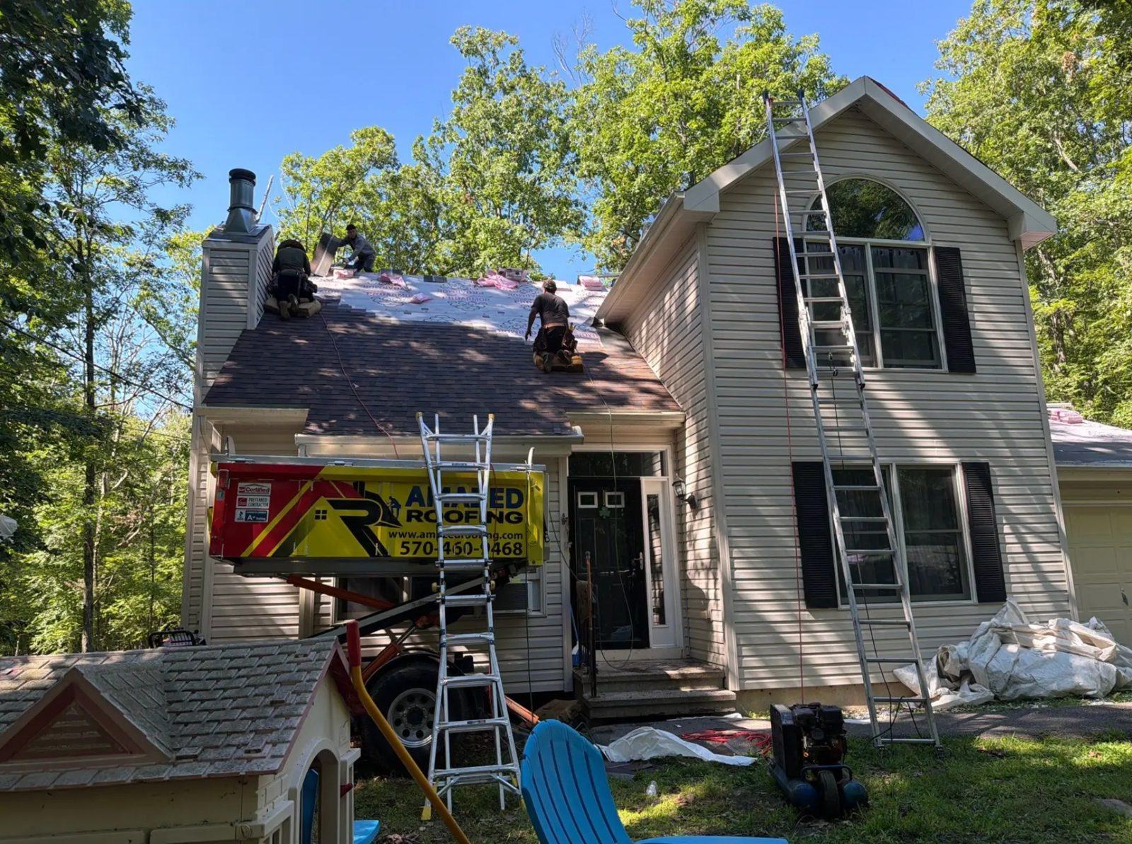 Crew installing new shingles, Poconos home